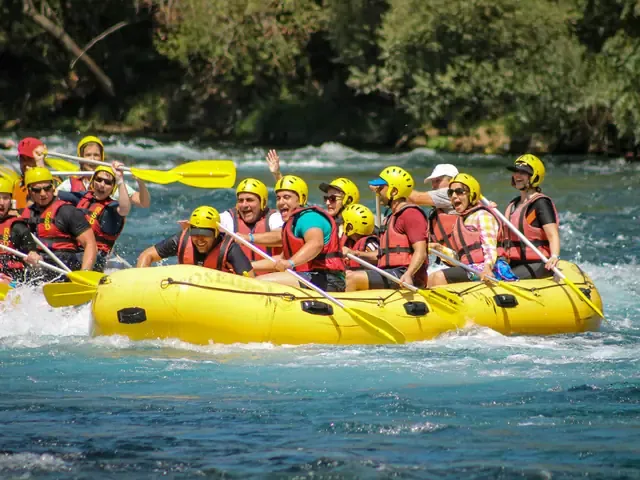 Un raft jaune plein de participants au passage d'un rapide